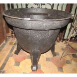 An old cast iron tub raised on possibly later associated Art Deco style tapered feet, 60 cm diameter