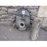 A 19th century lead and partially infilled face mask fountain head, the mask with defined