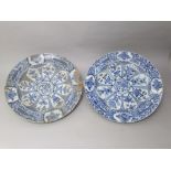 A pair of 19th century oriental blue and white chargers with painted floral detail, 42 cm diameter