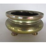 A Chinese cast bronze baluster sensor on three short feet, seal mark to base, 14cm diameter