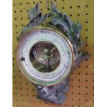 Impressive continental wall thermometer, the circular dial mounted by and eagle and wreath, with