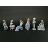 A collection of six Nao figure groups of children with their pets, a girl with a bird, etc