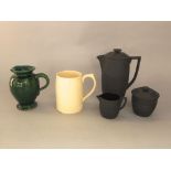 A three-piece Wedgwood black ground Keith Murray black basalt coffee set comprising covered coffee