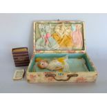 Interesting textile lined case, the hinged lid enclosing a porcelain doll with clothes and a scale