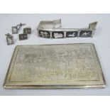 Persian/eastern silver card case engraved with a communal scene, 14cm long, 6oz approx; together