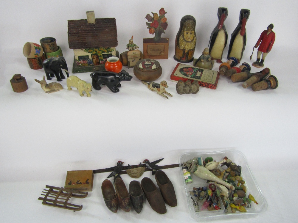 A mixed toy/treen lot to include Russian dolls, cottages, novelty corks, various animals and others