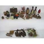 A mixed toy/treen lot to include Russian dolls, cottages, novelty corks, various animals and others