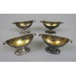 Set of four George III silver table salts, with twin scrolled handles and gilt interiors, engraved