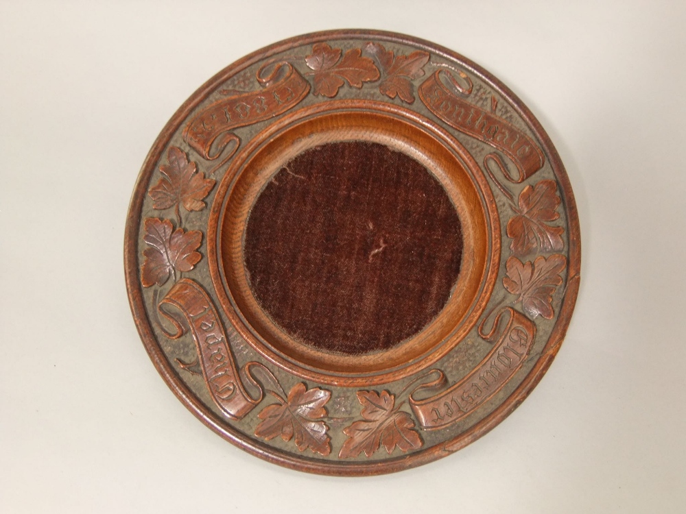 A Victorian carved oak offertory plate, circular with trailing vine leaf decoration, Southgate
