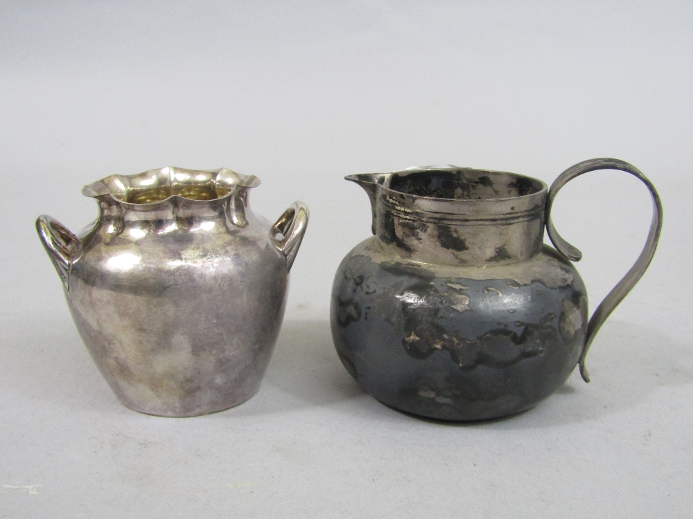 Early 20th century silver ovoid cream jug; together with a further silver sucrier, 9oz approx (2)