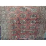 A pale pink Afghan wool rug with multi medallion centre, within alternating running borders, 180 x