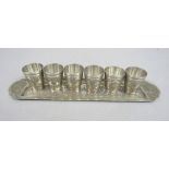 Persian silver set of six cups upon a long tray, all engraved with panels of foliage, the tray