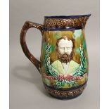 A 19th century majolica jug with relief moulded and decorated portraits of a bearded gentleman,