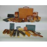 A box containing various leather and leather wares to include a small suitcase, various collar