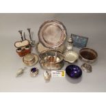 A box containing a collection of silver plated items to include various flatware, candlesticks,