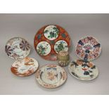 A collection of oriental ceramics including an early 19th century plate with bird and flowering tree