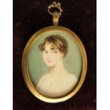 19th century school - Miniature bust portrait of a lady in a white dress, work on ivory, fitted into