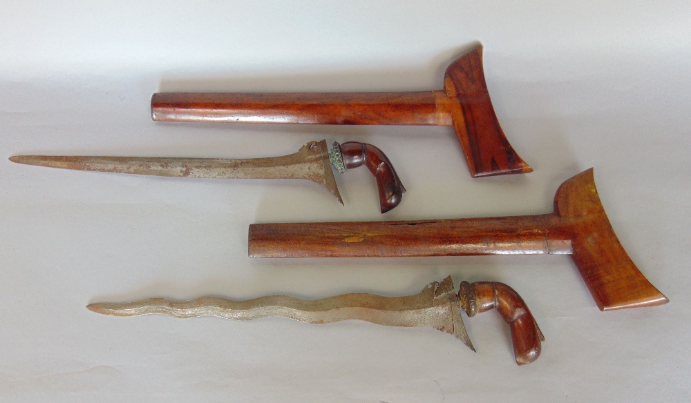Interesting pair of Persian daggers, with wavy blades in fruit wood sheaths, each 50cm long (2)