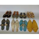 A box of various eastern textiles and fabrics together with a collection of Chinese shoes and