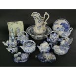 A quantity of mainly reproduction oriental blue and white ceramics including teapots in the form