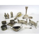 A collection of silver cruet items to include two white metal long boat salts (AF) a pair of