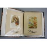 An album containing eight early 20th century Beatrix Potter greeting cards