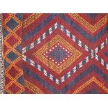 An eastern wool runner of narrow dimensions, multi medallion centre, set within running borders,