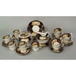 A collection of mid-19th century tea wares with painted floral sprays on a blue and gilt ground