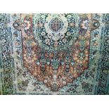 A cotton rug in the Persian style with central medallion, abstract floral surround and a repeating