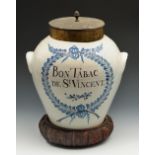 An 18th century tin glazed earthenware two handled tobacco jar with painted inscription Bon Tabac De