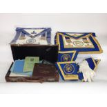 A leather case containing a collection of Masonic regalia together with further Masonic clothing