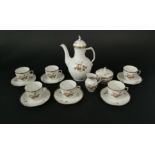 A six place Royal Copenhagen coffee service with brown and gilt floral detail, including coffee pot,