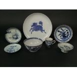 An oriental plate with prancing horse type creature on a relief moulded ground with cloud detail and