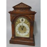 A German walnut two train bracket clock, the arched gilt face with subsidiary slow/fast dial, the