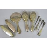 A collection of silver dressing items to include four brushes, dressing mirror, two boot horns and