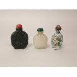 Three Chinese snuff bottles, two in jade and one in ceramic (3)