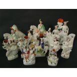 A collection of fourteen 19th century Staffordshire figures including a spill vase-Robin Hood, an