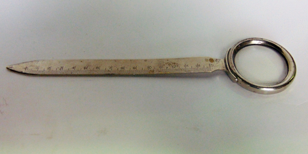 A vintage combined letter opener, rule and magnifying glass, in chrome finish