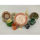 An interesting collection of pottery wares including a slipware dish of circular form with brown and