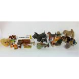 A box containing a collection of various novelty animals to include carved wooden study of a west