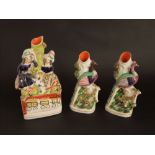 A 19th century Staffordshire spill vase in the form of male and female characters in highland