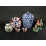 A collection of oriental ceramics including a blue and white jar and cover of ovoid form, a