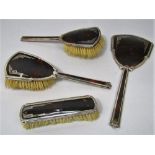 An attractive art deco silver and tortoiseshell pique ware four piece dressing set comprising