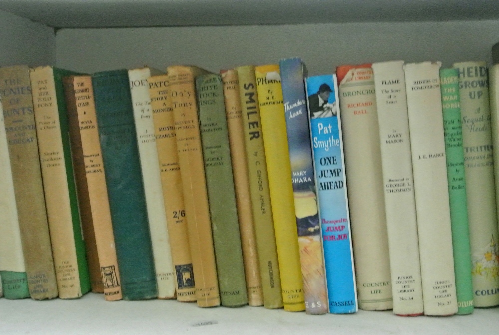 An extensive collection of vintage children's adventure books, many about horses, with original dust