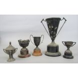 Five various silver trophies, four of which are set on plinth bases, the largest 24cm high (5)