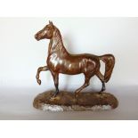 A cast bronze study of a standing horse, 21cm high