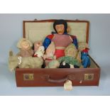 A vintage leather suitcase complete with various vintage teddies and dolls