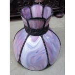 A Tiffany style hanging ceiling light shade with slag style glass panels, foliate banded neck and
