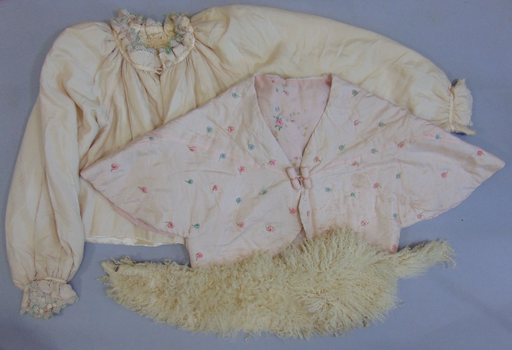 A pink silk bed jacket with hand stitching and applied flower decoration, a further bed jacket in