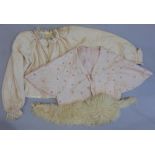 A pink silk bed jacket with hand stitching and applied flower decoration, a further bed jacket in